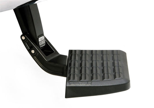 The AMP Research 2023 Ford F-250 Super Duty BedStep in black is displayed with its rugged, metal bracket. It showcases a textured, non-slip surface for safety and is engineered to retract seamlessly, providing convenient assistance for loading or unloading the truck bed.