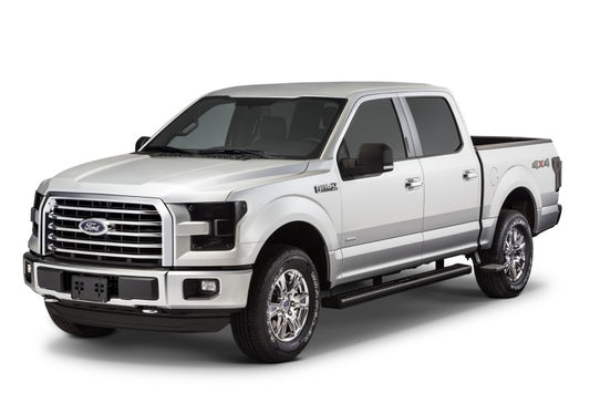 A sleek silver Ford F-150 pickup truck, complete with four doors and striking chrome accents, is skillfully positioned to highlight its front and side. Emphasizing the rugged 4x4 logo on the rear, it boasts retractable black side steps from AMP Research for effortless entry. The entire scene is presented against a pristine white backdrop.