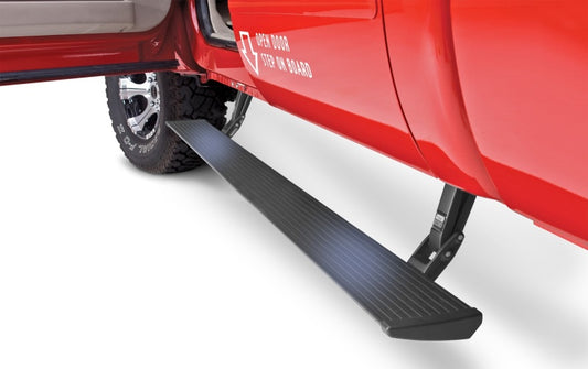 The AMP Research 2017-2017 Ford SD All Cabs PowerStep Plug N Play in black features an automatic running board that extends from the side under an open door. The phrase "open door, step in board" is elegantly displayed, showcasing its all-weather performance.