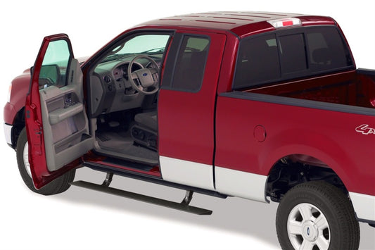 A Ford F150 SuperCrew, showcasing its luxurious interior through the open driver's side door, features striking red bodywork complemented by white lower panels. The truck is equipped with an AMP Research 2001-2003 PowerStep running board in black, providing automatic retractable access for convenience. Its rear truck bed is empty and ready for loading.