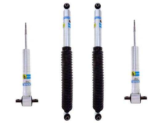 The image presents four 07-13 GM 1500 Leveling Kit shock absorbers by LTW Motorsports against a white background, showcasing a set with matching rear shocks. Two of them feature black accordion-style dust covers, while the other two are coverless. Each metallic absorber displays the distinct blue and yellow branding, emphasizing its modern design.