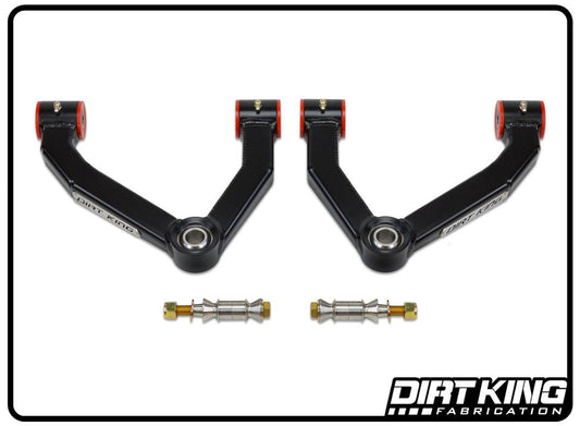 A pair of 15-22 Colorado/Canyon Boxed Upper Control Arms with red bushings and stainless steel uniballs, laid out on a white background. Designed for vehicle suspension systems, these control arms offer increased castor. The "DIRT KING" logo is visible in the bottom right corner.