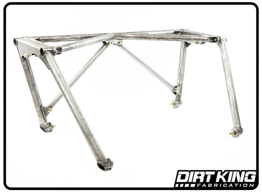 The 04-20 Ford F-150 Pre-fab Bed Cage by DIRT KING features a gray metal vehicle frame with multiple support bars and joints, resting on four legs with rubber-tipped feet, showcasing its intricate suspension system. The "DIRT KING FABRICATION" logo is visible in the bottom right corner of the image, emphasizing its renowned bed cage installation.