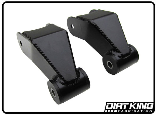 Close-up image of two black metal 04-20 Ford F-150 Long Travel Shackles by DIRT KING against a white background. The trapezoidal-shaped components, resembling factory shackles, feature rounded ends and visible welds along the edges. The "Dirt King Fabrication" logo is located in the bottom right corner.