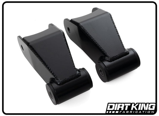 This image displays two black metal automotive components, specifically the 19-24 GM 1500 Long Travel Shackles from DIRT KING. They include cylindrical bushings at one end and are robustly constructed with visible welds. The logo in the bottom right corner reads "DIRT KING Fabrication.