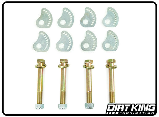 A set of metallic components arranged neatly: eight uniquely shaped silver plates, each with a perforated pattern, four large gold-colored 10.9 bolts with accompanying nuts and washers, and two alignment cams from the 19-24 GM 1500 Lower Arm Alignment Cams kit by DIRT KING. The image has a white background with the "DIRT KING FABRICATION" logo in the bottom right corner.