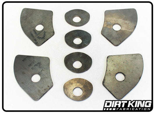 The "99-18 GM 1500 Lower Arm Weld Washers" by DIRT KING consist of seven metal automotive hardware pieces, including two large, irregularly-shaped plates, four smaller oval pieces, and one circular weld washer, all placed on a white background. The logo "DIRT KING Fabrication" is located in the bottom right corner.
